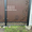 Распашные ворота из профлиста с бетонным забором #1736614